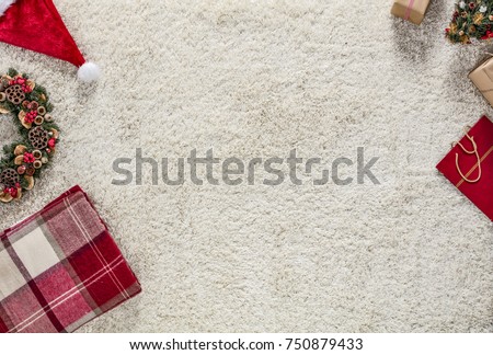 Photo taken from above. Wooden floor and bright carpet. Christmas decorations arranged evenly. Place your product or ad text or slogan.