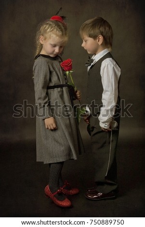 the boy gives a rose to the little girl as a sign of love on a date