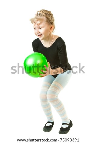 A girl playing with a green ball