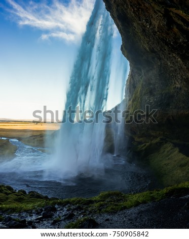 Cave behind Seljalandsfoss Waterfall in Iceland with long Exposu