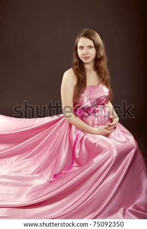 beautiful pregnant girl in a pink dress