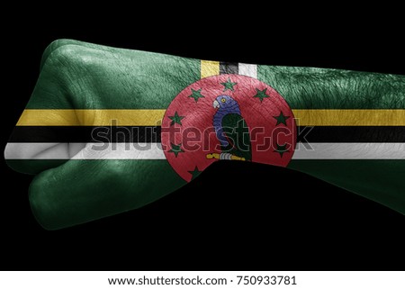 Fist painted in colors of Dominica flag, fist flag, country of Dominica