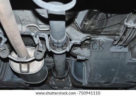 Car suspension, car bottom, repair, a prestigious transport, horizontal image, car standing on the logs, inspection car below.