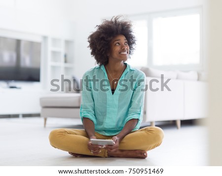 beautiful young black women using tablet computer on the floor at home