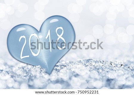 2018, close up on a ice heart in the snow Royalty-Free Stock Photo #750952231