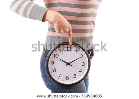 Portrait of a healthy woman holding a clock, isolated on white studio background