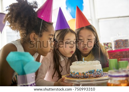 A Group of three adorable kids having fun at birthday party