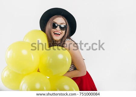 Young pretty woman with yellow balloons
