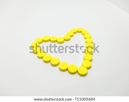 Close up yellow medicines on the white background.