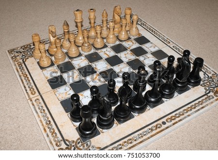 chess old, wooden on an old stone marble board