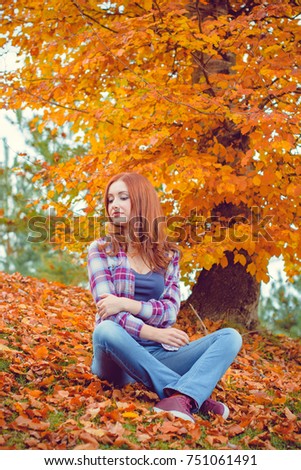 Beautiful hipster traveler with around autumn trees in woods. Stylish woman hiking. adventure and travel concept or rest at weekend on a nature, atmospheric moment