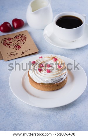 Lemon Tart with meringue and cup of coffee, milk with holiday decorations for Valentines day. Sweet Candies in form of heart. Red paper note message card For You