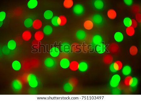 Christmas or holiday bokeh background, copy space. Defocused new year bokeh lights, free space. Blurred red and green bokeh. Abstract holiday glitter background. Lens flare pattern