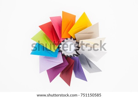Propeller of colored envelopes on the white table