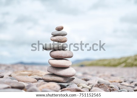 Pile of balance pebble stones in a pyramid shape with mountain background. Zen meditation . Kerry, Ireland- 2016.