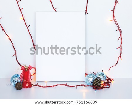 Mock up poster in interior. White vertical canvas lean at wall. Christmas decoration.
