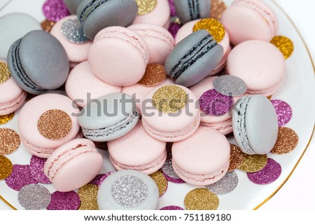 Pink and Grey macarons with sparkling decoration. White background. Holiday dessert.
