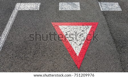 Inverted white with red border triangular road sign yield that you need to wait and give other cars the right to pass