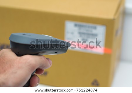 Great concept of traceability, ERP system, hand crawling product barcode and packaging.
The man gets on the hip scanner in operations directed on printed barcode. Warehouse scene. Shallow DOF! Royalty-Free Stock Photo #751224874