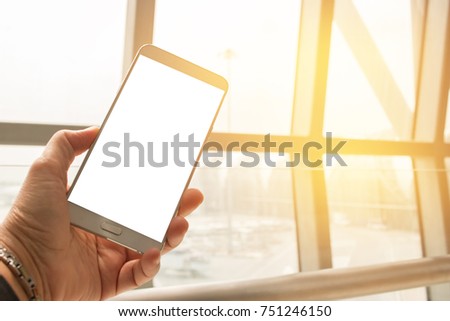 Hands holding use smart phone in airplane blurred background, mock up blank advertising template. insert for text of customer. Space for texting in your products or promotional.