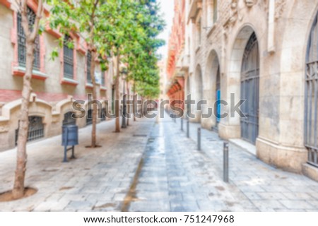 Defocused background of a scenic street in La Ribera district of Barcelona, Catalonia, Spain. Intentionally blurred post production for bokeh effect