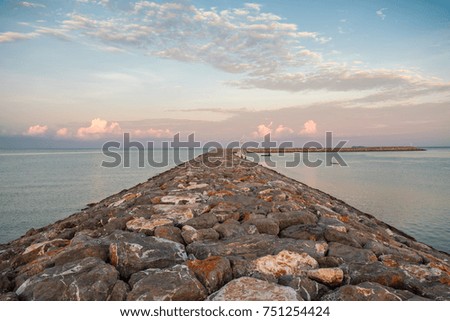 Embankment of the sea with sunset sky background.
