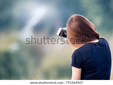  young woman is making selfie photo with smartphone.
