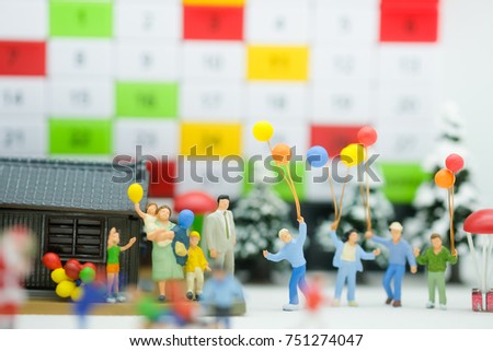 Miniature family with balloon and colorful calendar using as background family day concept.