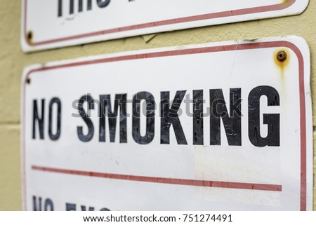 No smoking sign on a painted brick wall