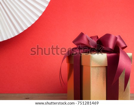 Valentine festival , New year Gold gift box with red ribbon. Red background for create idea copy space.
