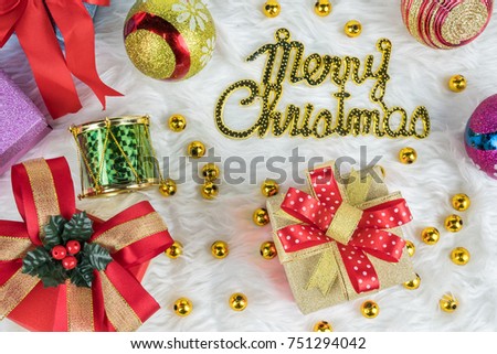 Merry Christmas background gold gift box with red ribbons and decorations on white mink cotton background. top view.Celebration Christmas festival 