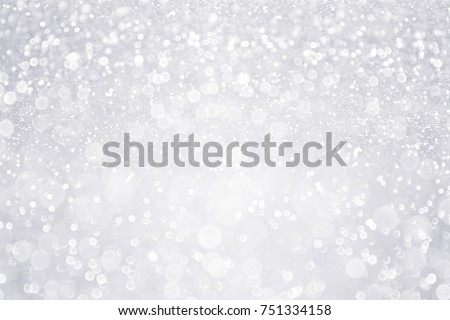 Silver white glitter sparkle confetti background for happy birthday party invite, Christmas fairy lights bokeh blur wallpaper, winter snow frost ice flyer, 25 anniversary or wedding glam spark shine Royalty-Free Stock Photo #751334158