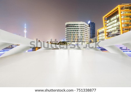 Empty square floor and modern cityscape at night in Shanghai,China