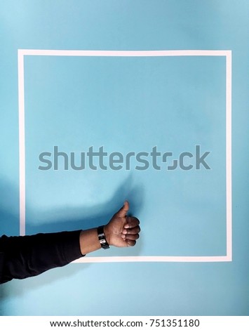 African-American Thumbs Up in Front of Blue Background Contained by Minimalistic Artistic White Square