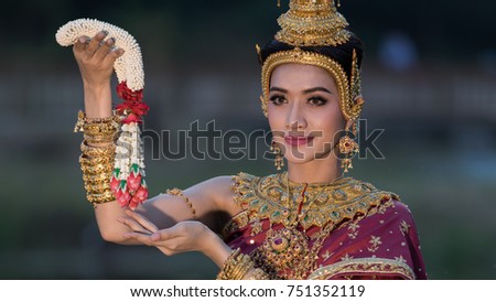 beautiful woman thailand wearing thai traditional handing garland flowers standing smile in the garden
