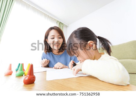 A parent and child painting a picture