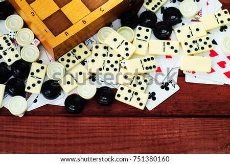 Various board games chess board, playing cards, dominoes. Hobby. Metaphor for games and gambling.