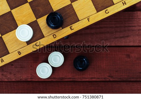 Sports or recreation Board game board with checkers. Hobby. Checkers on the playing field for the game.