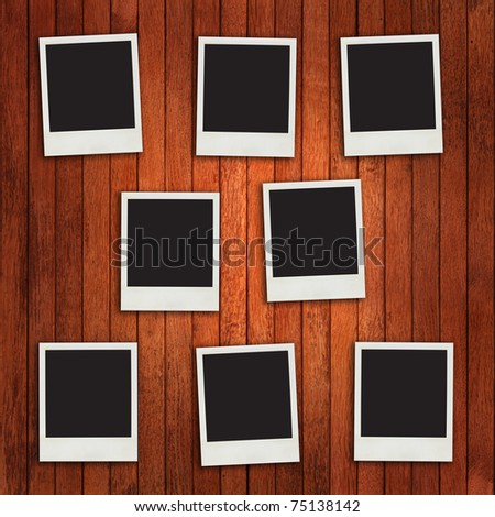 Photo frames on timber wall