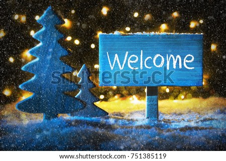 Sign With English Text Welcome. Blue Christmas Tree With Snow And Magic Glowing Lights In Backround And Snowflakes. Card For Seasons Greetings.