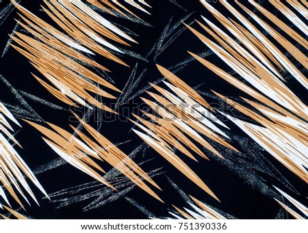 texture of silk fabric. background. Yellow brown white stripes line. On a black background. Brilliant line.