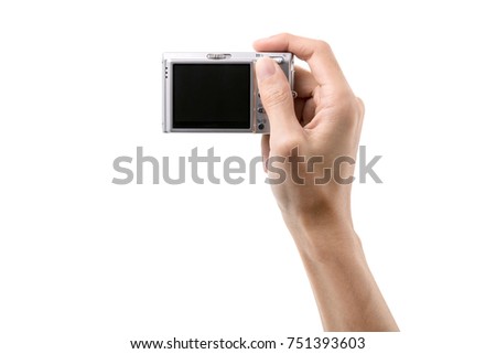 Digital camera in hand isolated on white background