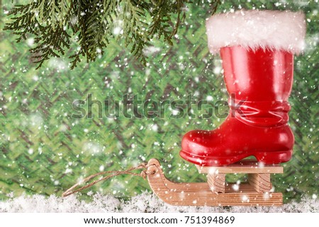 Red christmas boot on a sled with copyspace.  Christmas background 