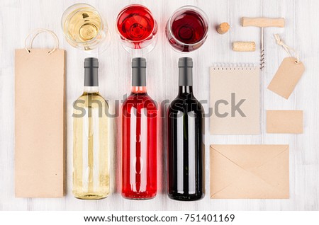 Corporate identity template for wine industry -  blank packaging, stationery, wine bottles and glasses on soft white wood background.