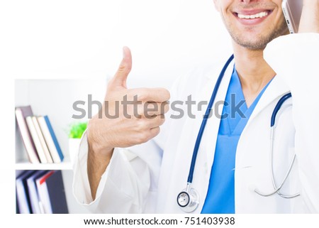doctor with stethoscope and thumbs up in sign of success and okay