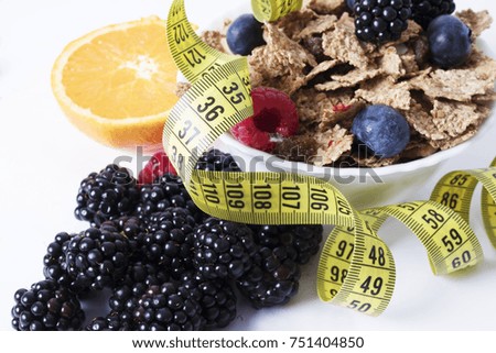fruits with cereals and tape measure, diet concept