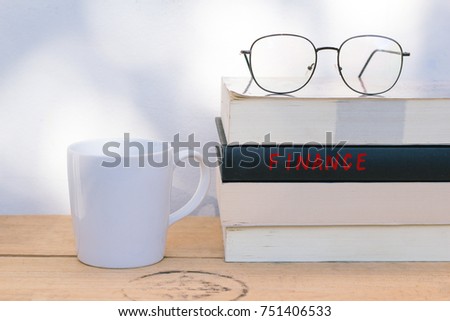 A cup of coffee and finance textbooks  with copy space