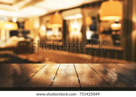 Abstract blurry restaurant interior background with empty wooden table. Mock up Royalty-Free Stock Photo #751425049