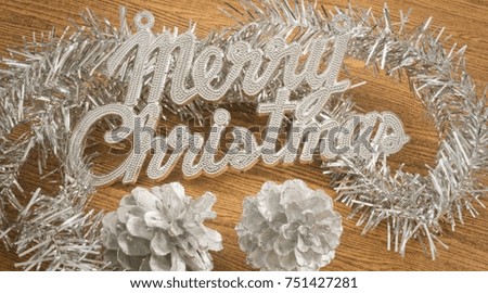 Xmas Ornaments, Merry Christmas Text with Baubles and Pinecones on Wooden Table, Sign for Christmas Celebration.