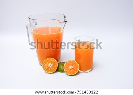 tangerine orange juice in a glass and pitcher on white background. concept of picture for a good health , clean food , diet.